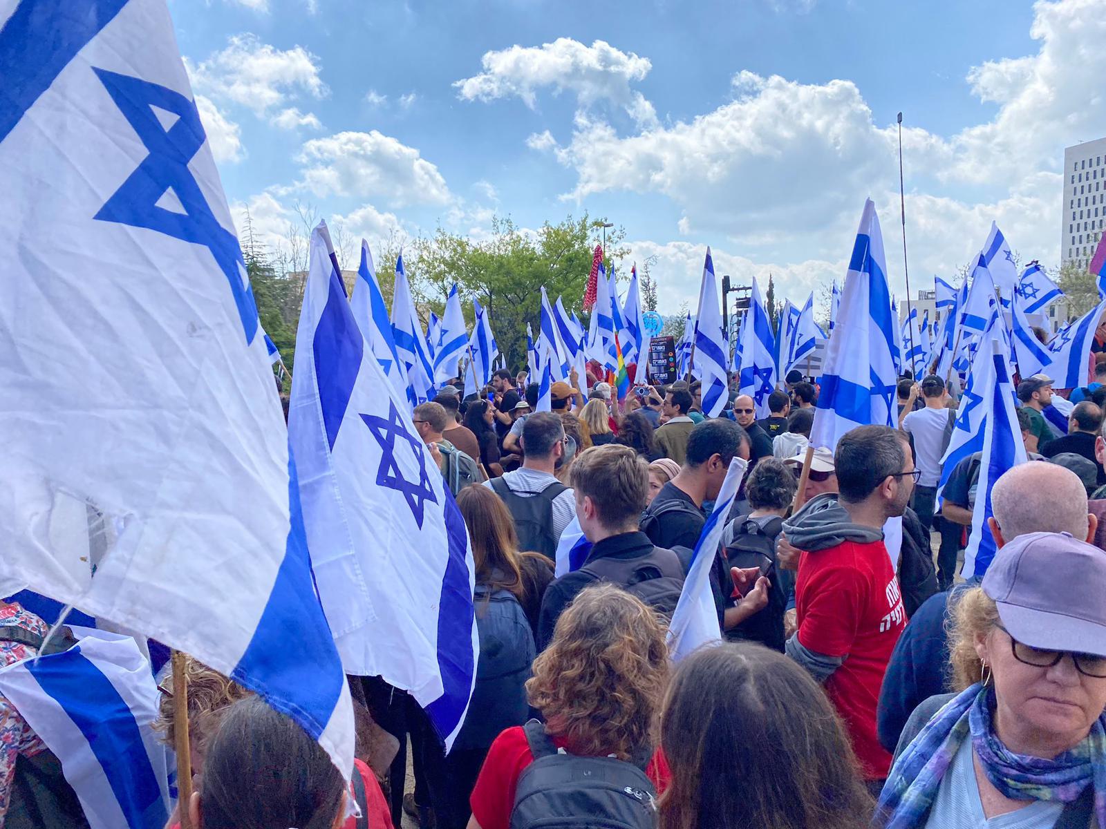 Israelis protesting with flags in front of Supreme Court