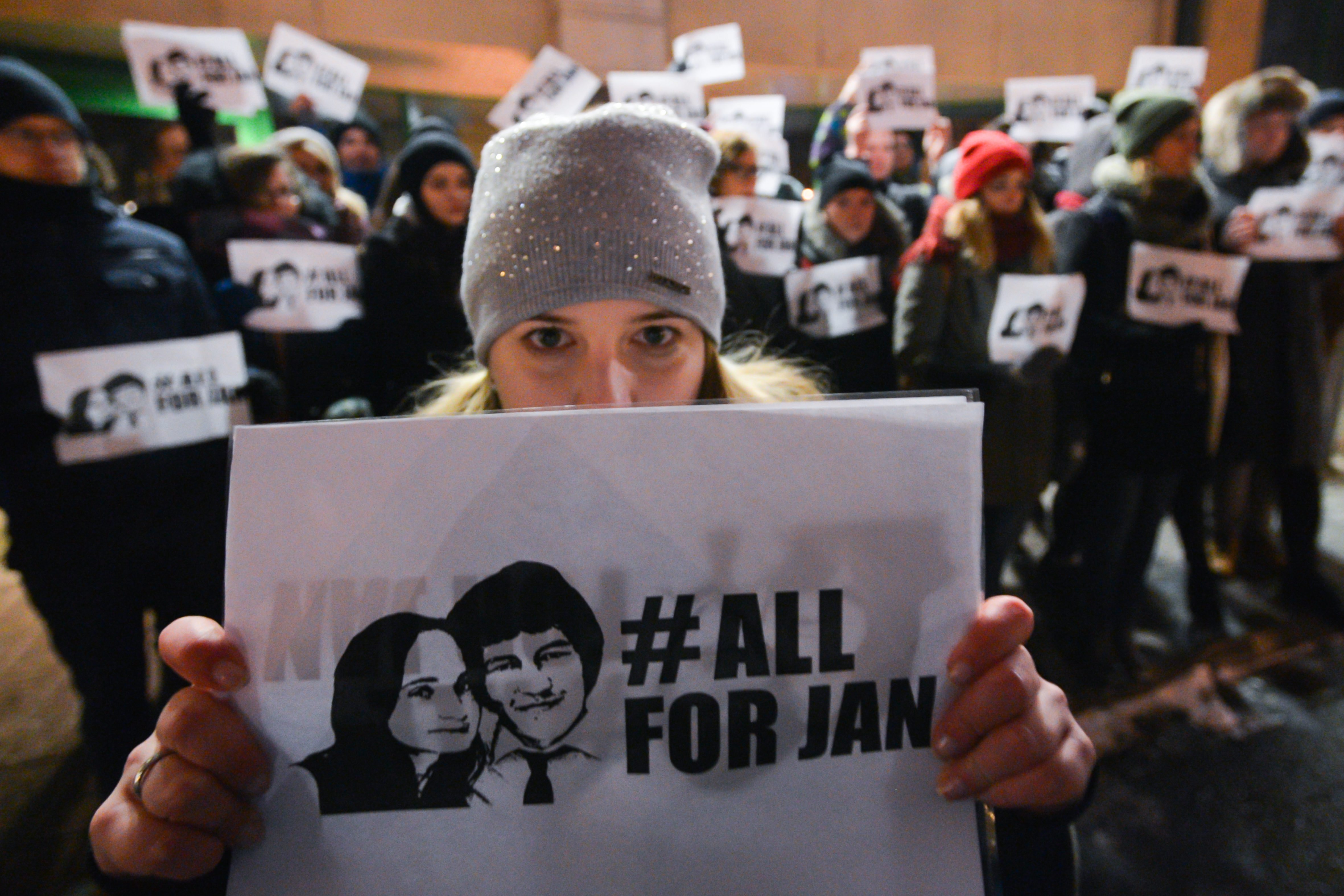 People hold a candle-lit vigil in front of the Consulate General of the Slovak Republic in Krakow, in memory of the journalist Jan Kuciak and and his fiancee Martina Kusnirova,
