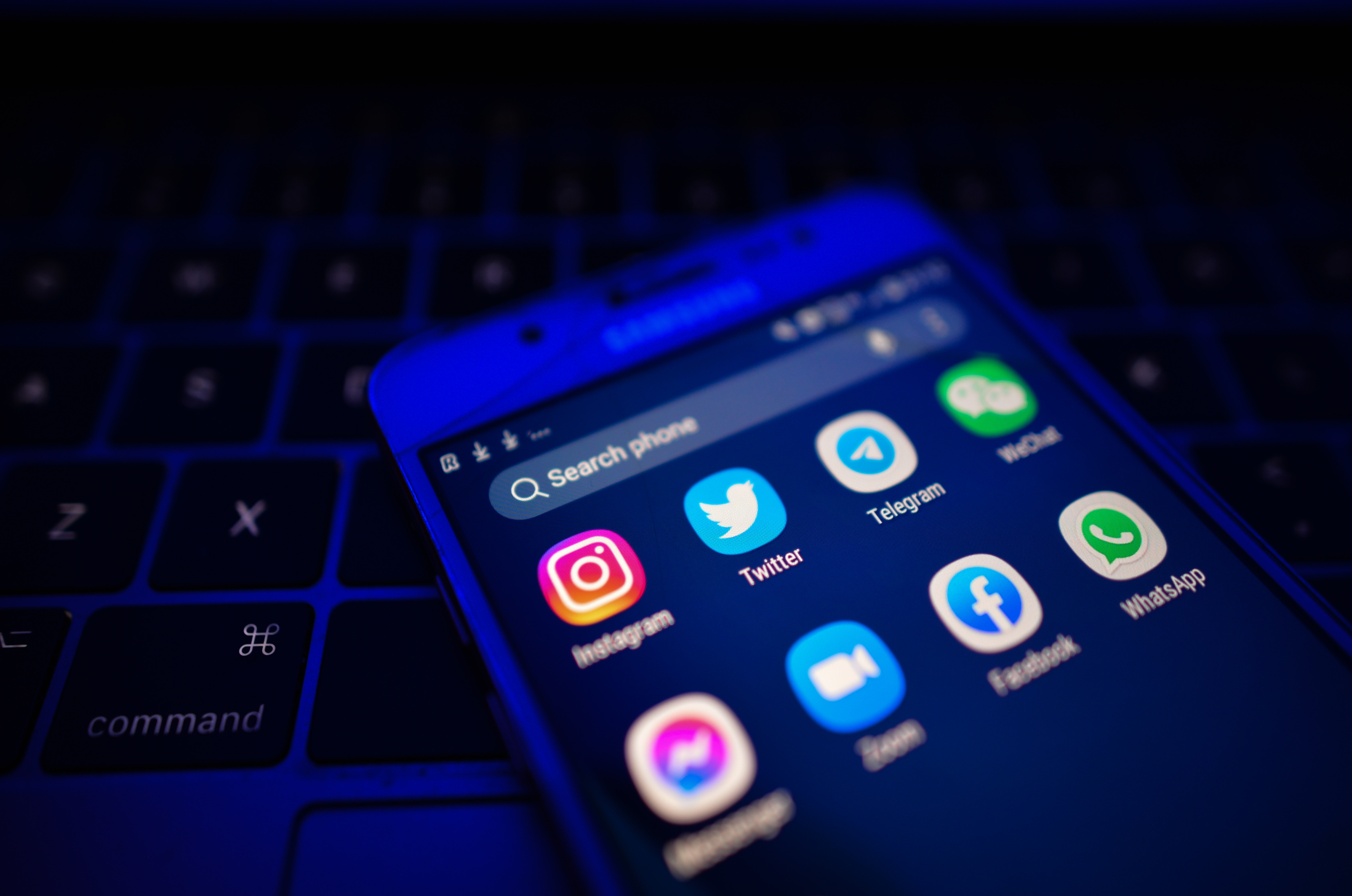 An illustrative image showing social media, chat and communication apps displayed on a mobile phone. 