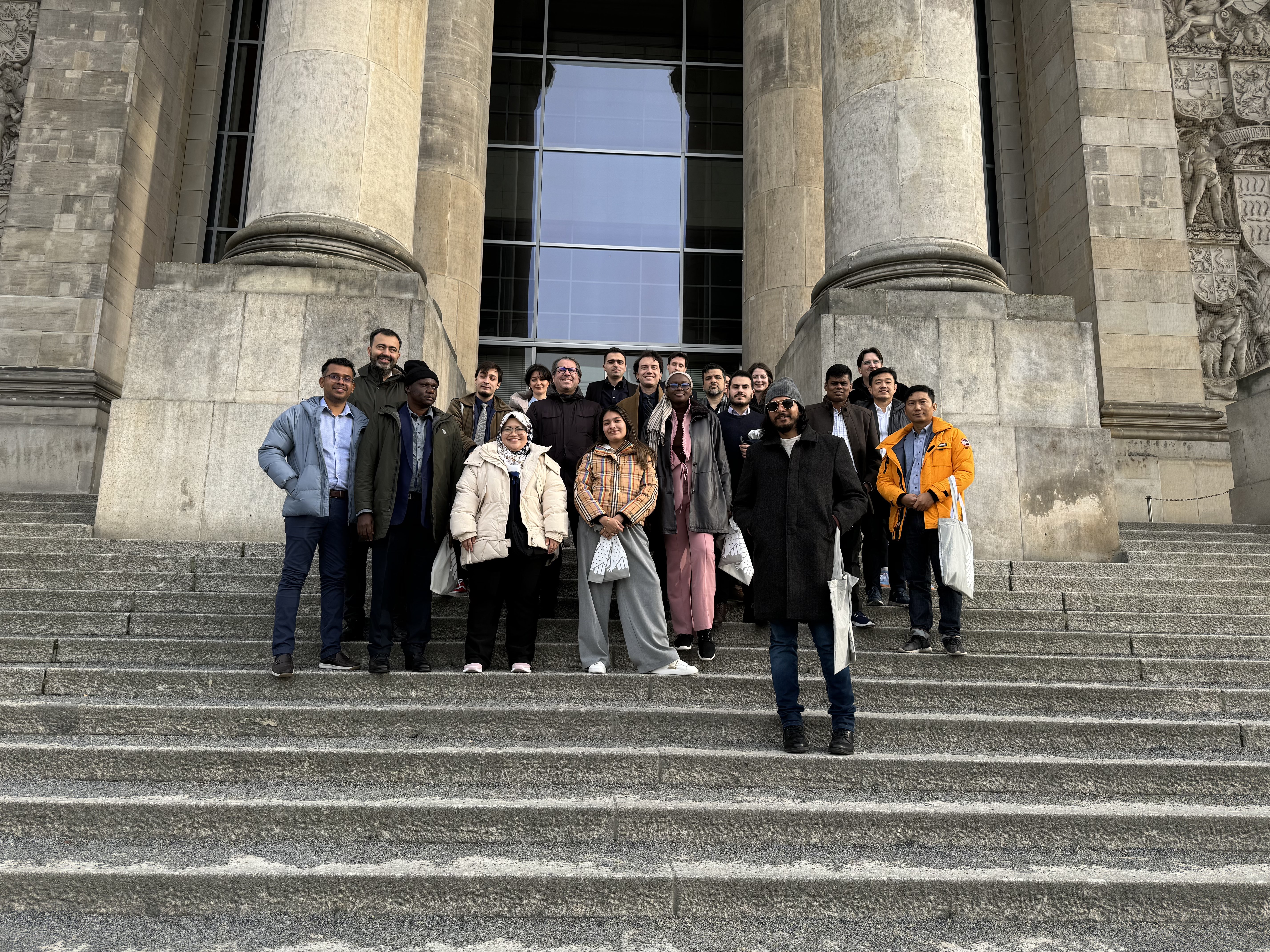 Nurhuda Ramli (author) standing with the other IAF participants on grand staircases in front of a building