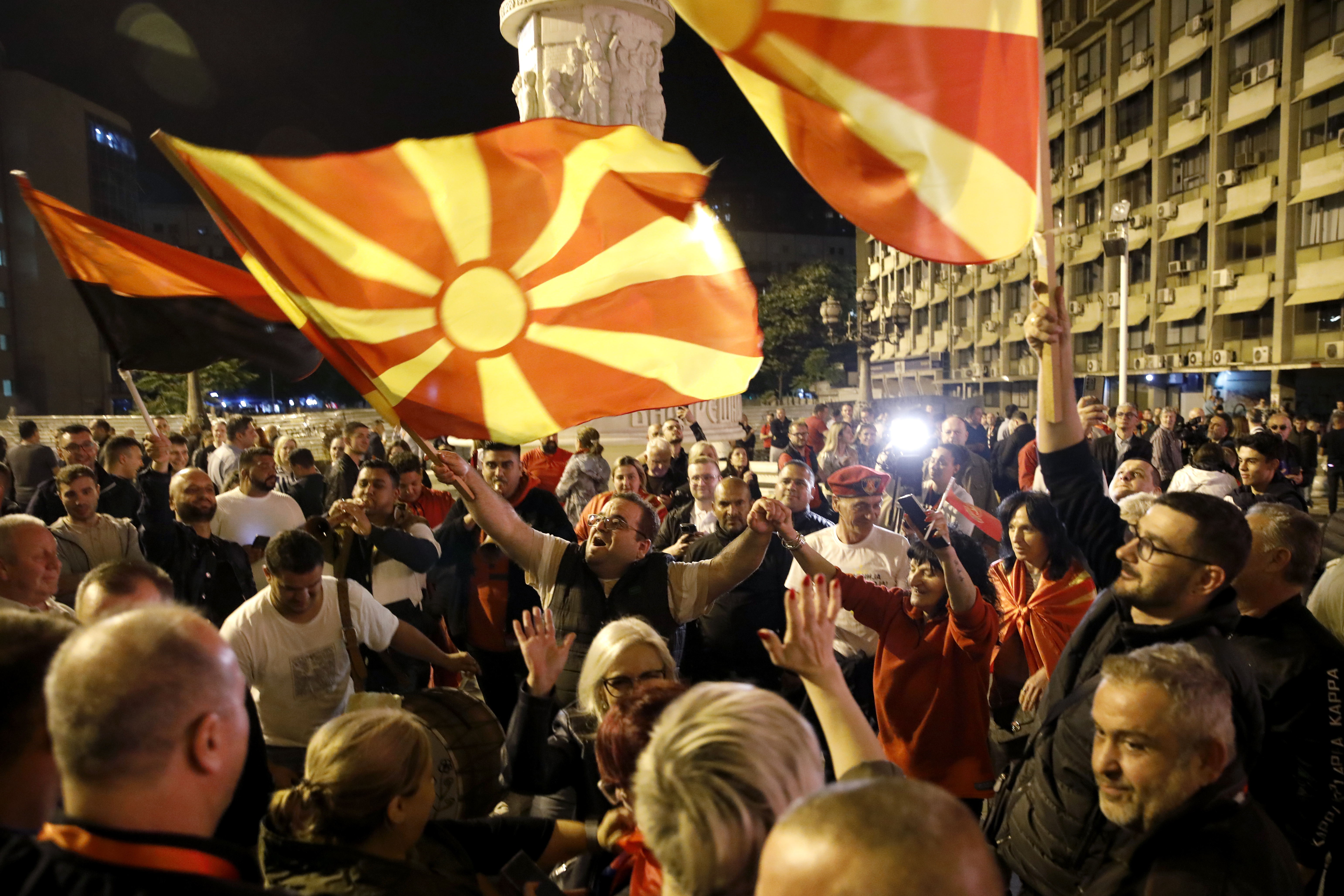 Supporters of the opposition center-right VMRO-DPMNE party celebrate in front of the party headquarters after their party announced victory in the presidential and parliamentary elections, in Skopje, North Macedonia, late Wednesday, May 8, 2024. (