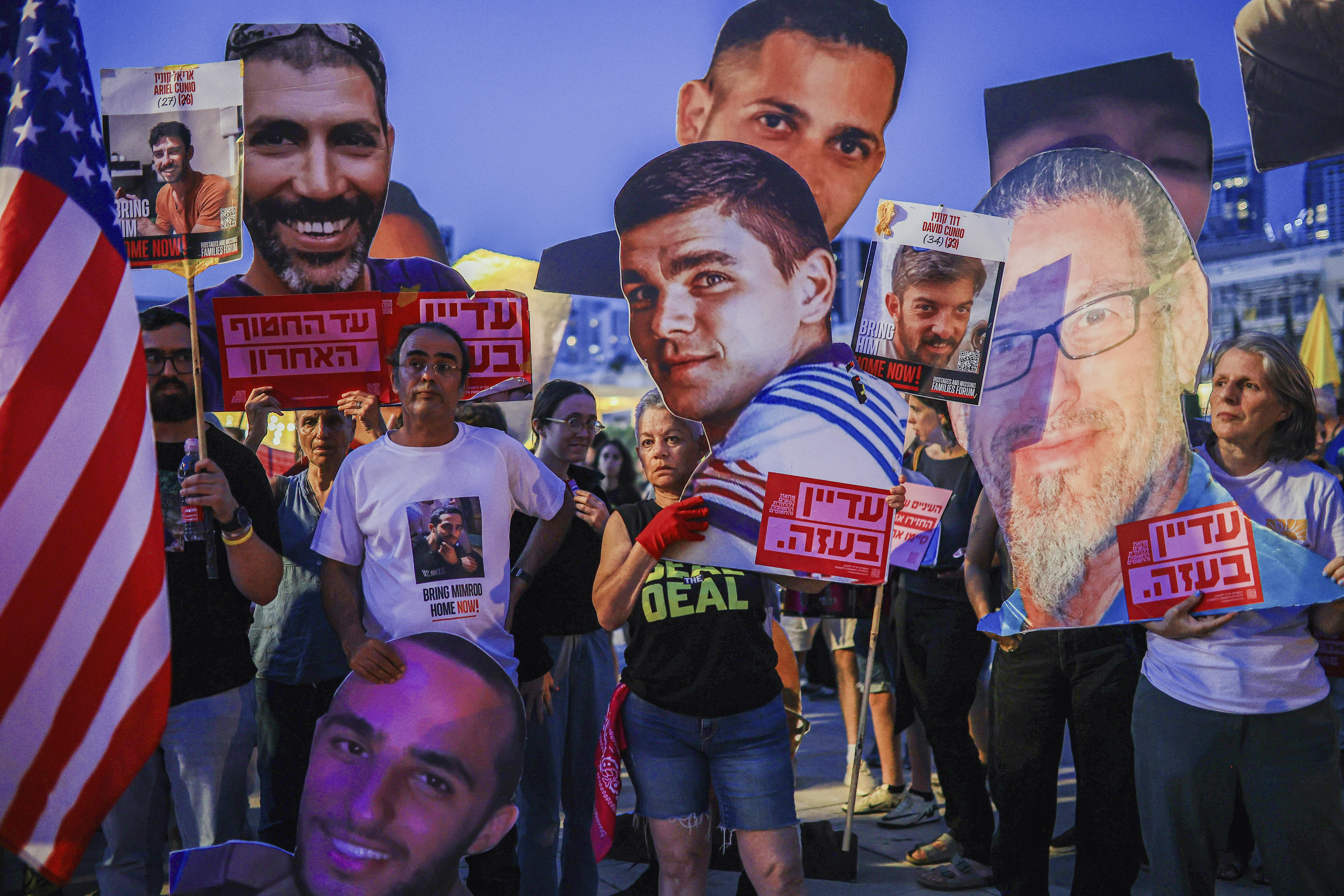 Israelis hold posters of hostages and US flags as they march to demand freedom of all of the hostages held in Gaza,