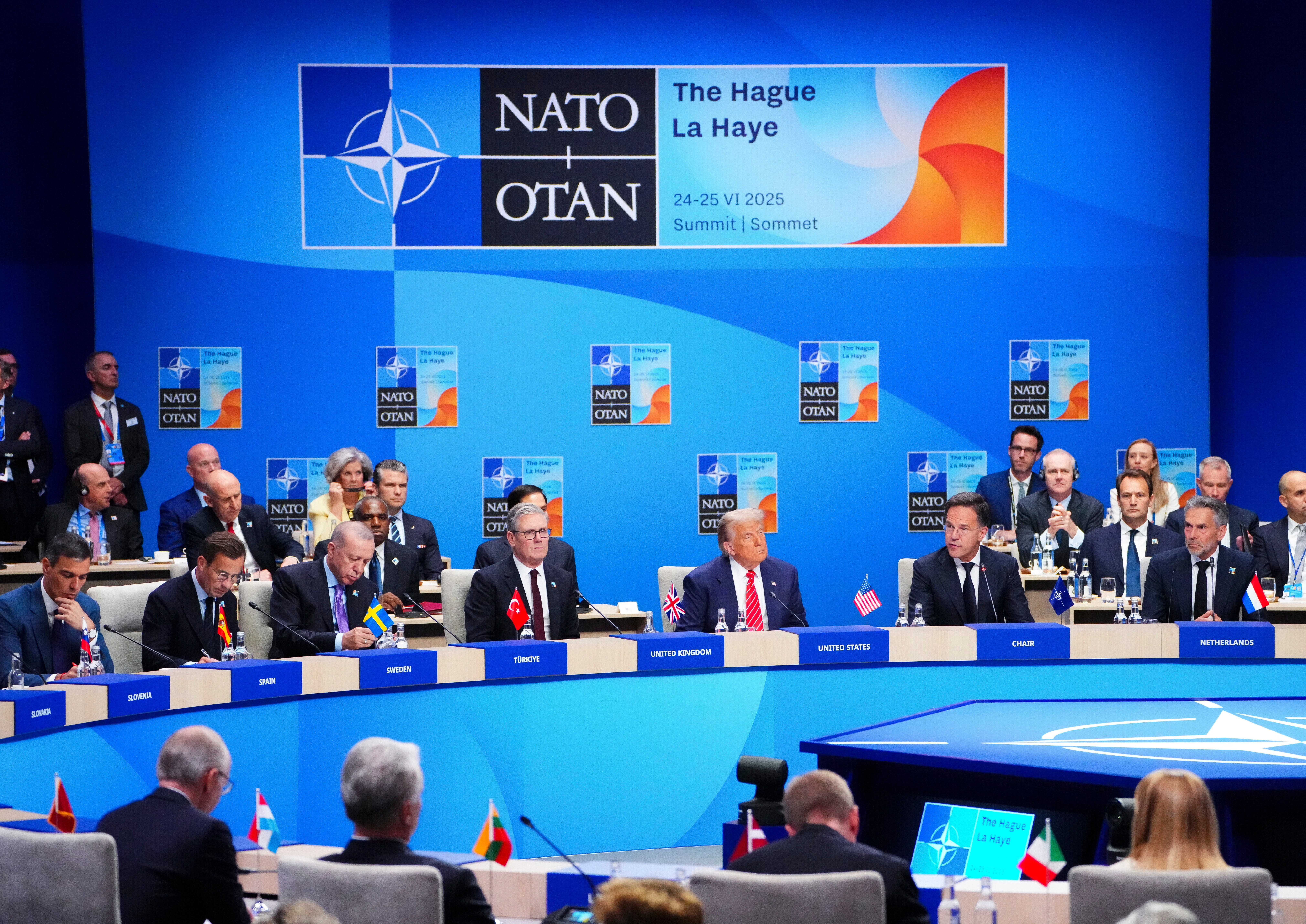 NATO Secretary General Mark Rutte, center right, gives the opening speech as he sits next to US President Donald Trump during a meeting of the North Atlantic Council at the NATO summit in The Hague.
