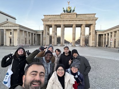 Nurhuda Ramli (author) standing with the other IAF participants in front of the Bradenburg Gate