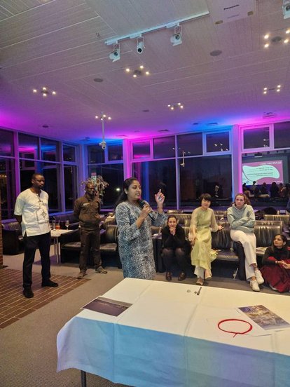 While attending the cultural night, Kasturi seems to be holding the attention of several of the people around her. She is in the middle of explaining something about her culture from back home.