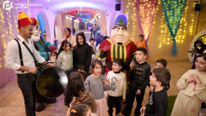 Children enjoy the festive spirit with traditional characters and drumming at the Ramadan Refugee Market.
