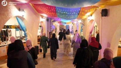Visitors walk through the beautifully lit market corridors, enjoying the diversity of handmade crafts.