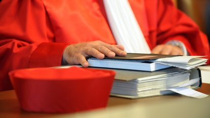 Ein Richter des Zweiten Senats beim Bundesverfassungsgericht in Karlsruhe hält am Dienstag (28.10.2008) bei der mündlichen Verhandlung über zwei Wahlprüfungsbeschwerden gegen den Einsatz von mehr als 1800 Wahlcomputern bei der letzten Bundestagswahl, eine Hand auf seine Unterlagen. Foto: Uli Deck dpa/lsw +++(c) dpa - Report+++