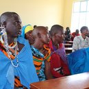 Women and Men sit in meeting room