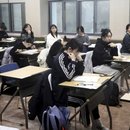 Students are waiting to take the annual university admission at a school 