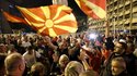 Supporters of the opposition center-right VMRO-DPMNE party celebrate in front of the party headquarters after their party announced victory in the presidential and parliamentary elections, in Skopje, North Macedonia, late Wednesday, May 8, 2024. (