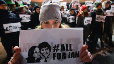 People hold a candle-lit vigil in front of the Consulate General of the Slovak Republic in Krakow, in memory of the journalist Jan Kuciak and and his fiancee Martina Kusnirova,
