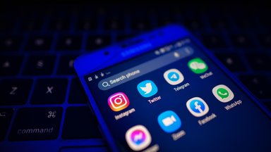 An illustrative image showing social media, chat and communication apps displayed on a mobile phone. 