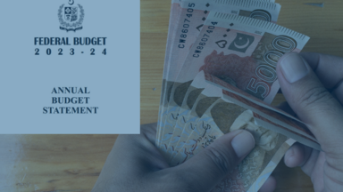 Man counting PKR 5000 notes with the overlay the budget document screenshot