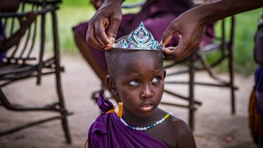 maasai-girl-tries-on-crown-in-tanzania-shutterstock.jpg