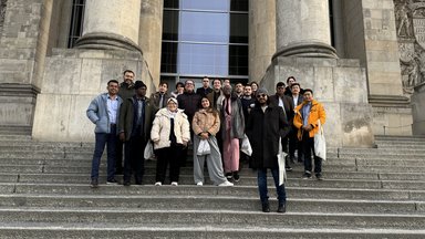 Nurhuda Ramli (author) standing with the other IAF participants on grand staircases in front of a building