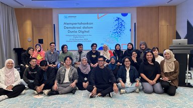 A group photo of the participants and Rahman Imuda (the facilitator; black shirt; centre).
